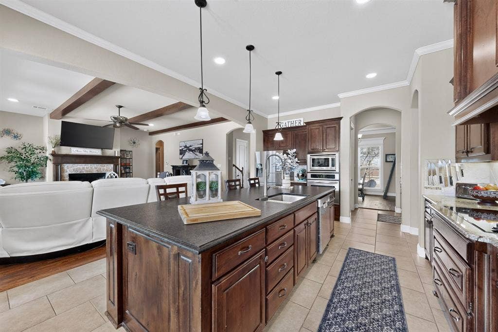 5020 Lindy Court, Midlothian, TX 76065 Expansive kitchen island with dark countertops and wood-finish cabinetry