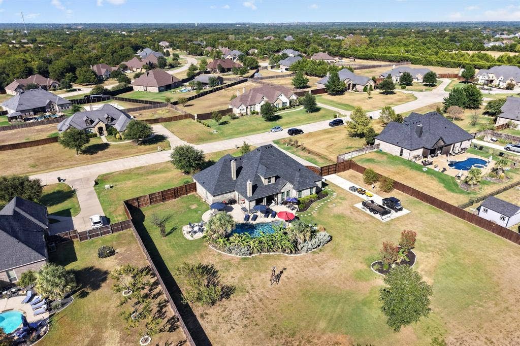 5020 Lindy Court, Midlothian, TX 76065 Expansive residential property with an in-ground swimming pool, a dedicated pool deck, and mature landscaping