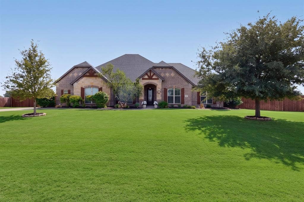 5020 Lindy Court, Midlothian, TX 76065 Brick and stone exterior featuring multiple gables, decorative timber accents, and a covered entry