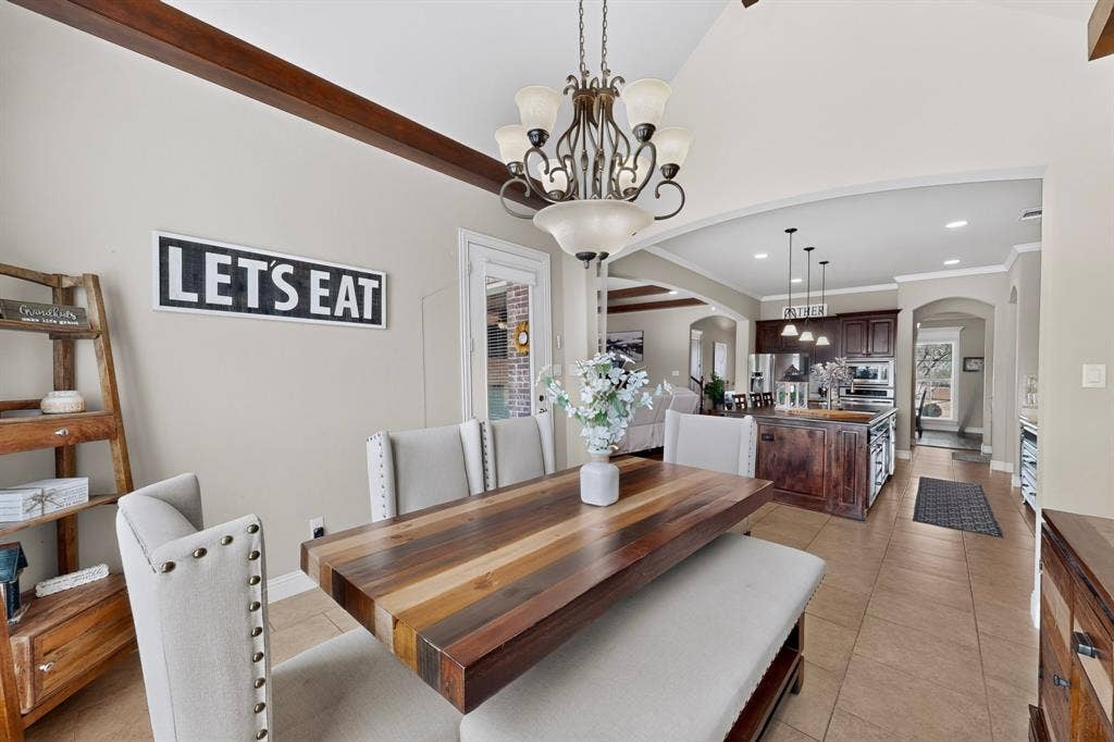 5020 Lindy Court, Midlothian, TX 76065 Tray ceiling with exposed wood-finish beams, arched doorways, tile flooring, and recessed lighting