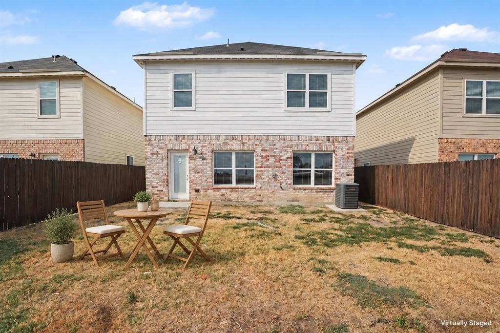 257 Michelle Drive, Grand Prairie, TX 75051 Virtually staged with outdoor furniture to illustrate a simple seating area. The fenced backyard offers space to relax outdoors.