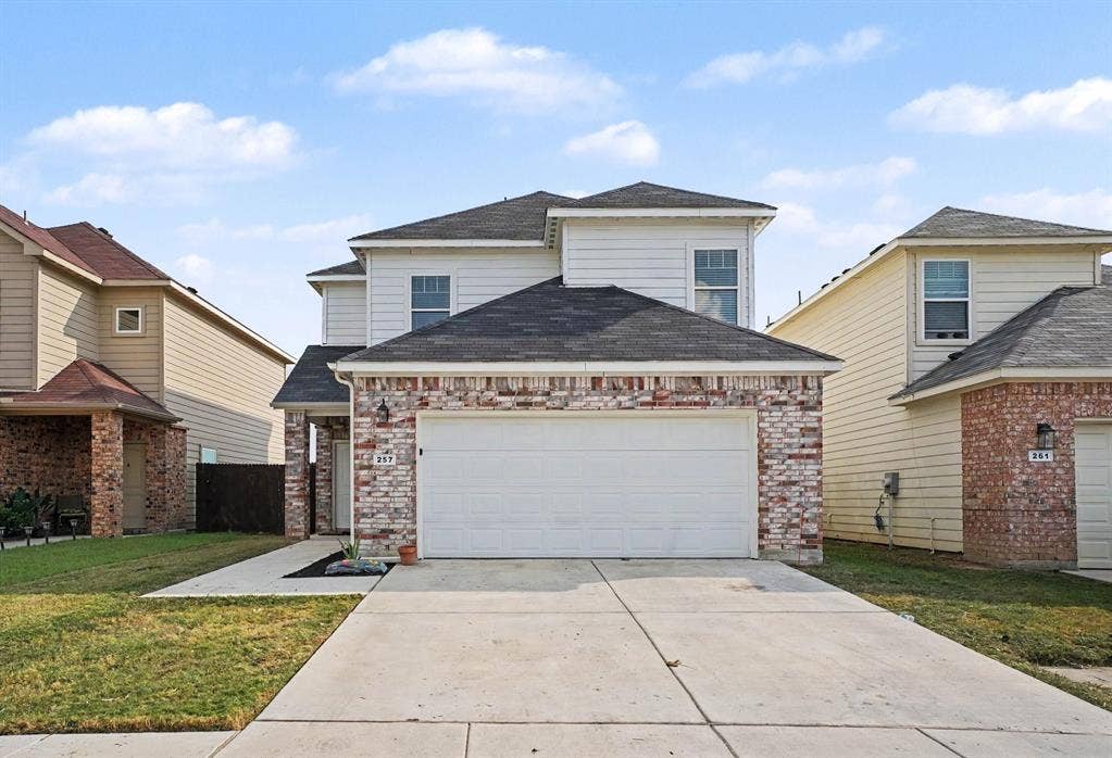 257 Michelle Drive, Grand Prairie, TX 75051 A closer look at the front exterior, lawn and two-car garage.