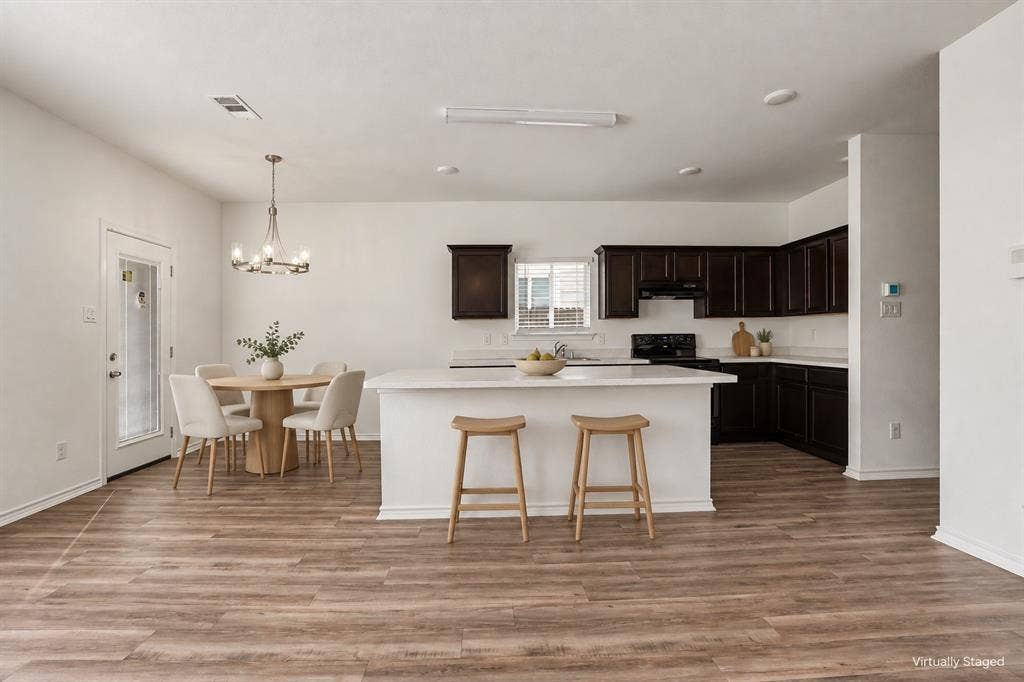 257 Michelle Drive, Grand Prairie, TX 75051 Virtually staged. The kitchen island offers casual seating, with a dining area beside the back door.