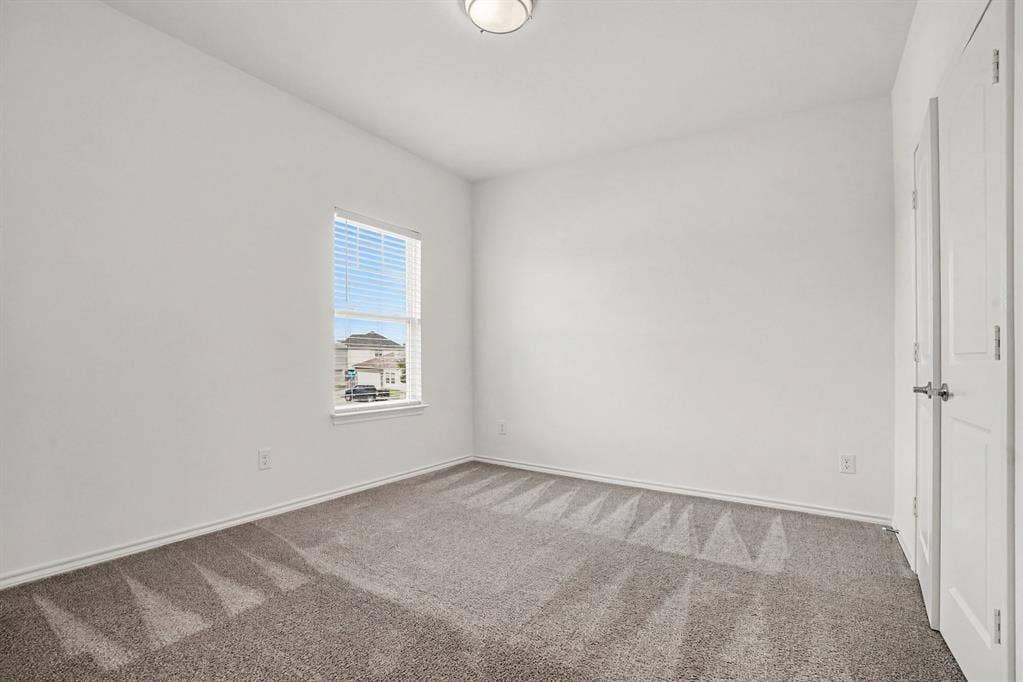 257 Michelle Drive, Grand Prairie, TX 75051 A secondary bedroom with neutral finishes and natural light.