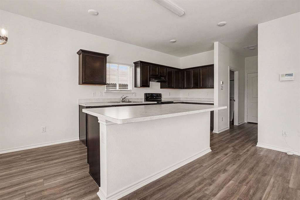 257 Michelle Drive, Grand Prairie, TX 75051 The kitchen island adds prep space and a natural gathering spot.