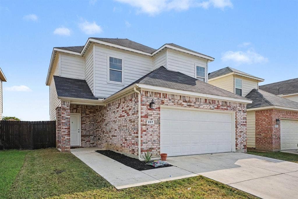 257 Michelle Drive, Grand Prairie, TX 75051 An angled front view highlights the brick exterior and walkway to the front door.