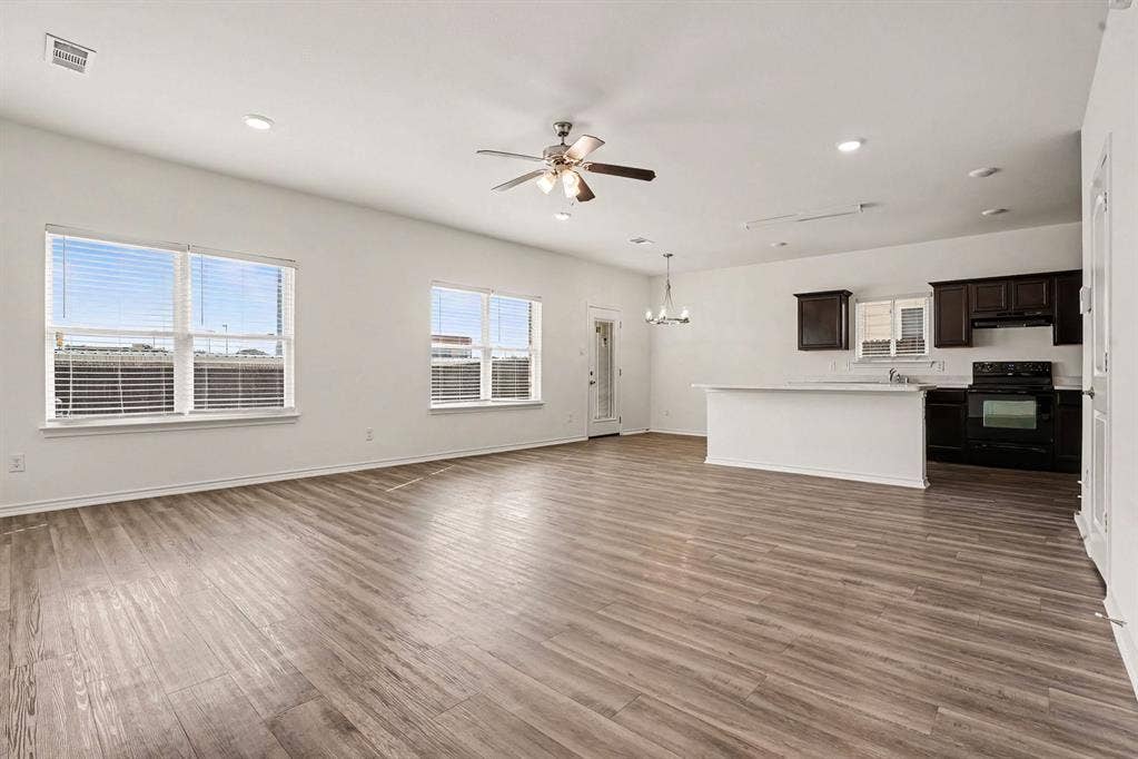 257 Michelle Drive, Grand Prairie, TX 75051 Windows bring natural light into the open living area, with the kitchen close by.