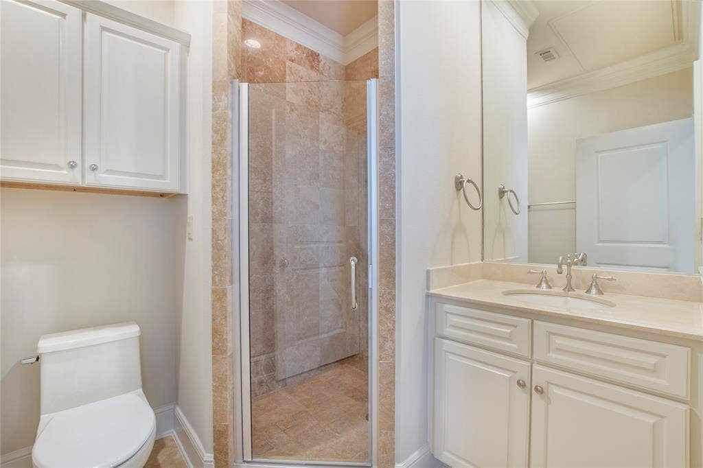 6525 Bandera Avenue, #2A, Dallas, TX 75225 Bathroom featuring toilet, ornamental molding, walk in shower, and vanity