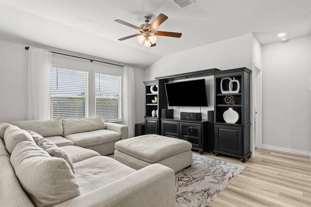 Vaulted ceiling featuring a ceiling fan