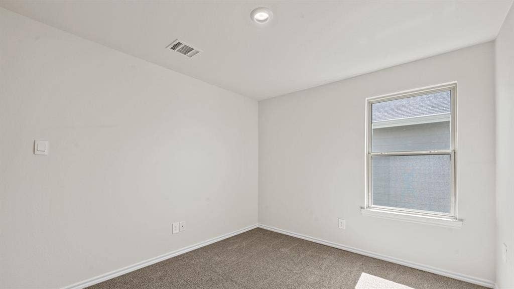 Recessed ceiling lighting, a single window, and neutral wall paint