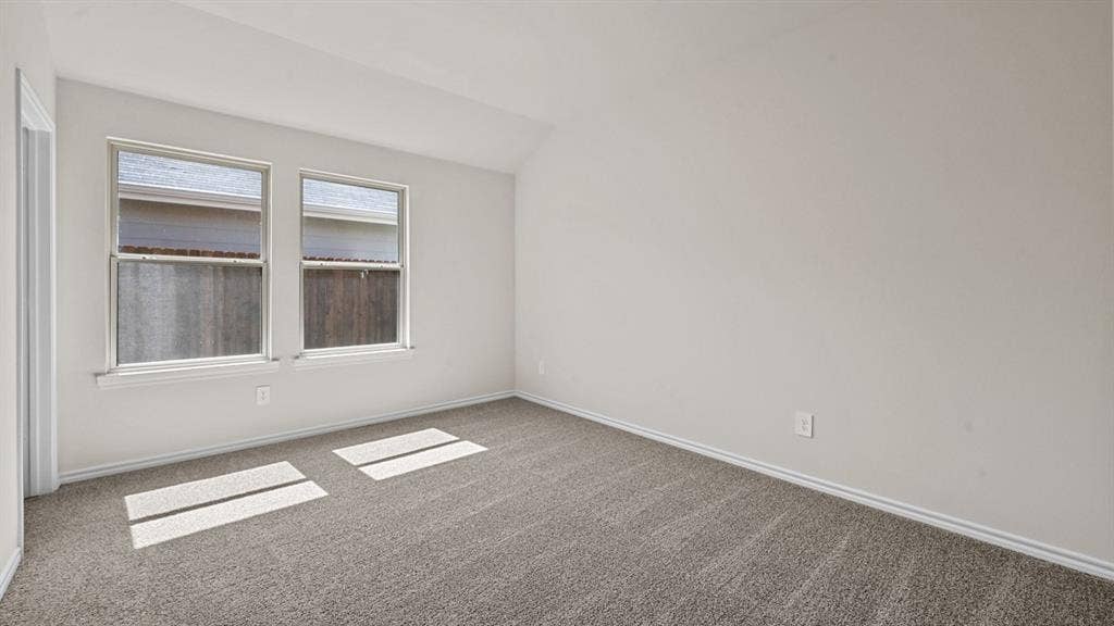Vaulted ceiling, two pane windows, neutral wall color, gray carpet, white trim