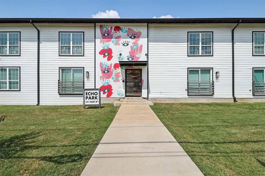 321 E 8th Street, #218, Dallas, TX 75203 White horizontal siding exterior with black trim windows