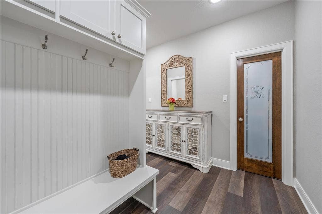 14486 Meadow Glen, Lindale, TX 75771 Built-in storage bench with beadboard paneling, upper cabinetry, and integrated coat hooks