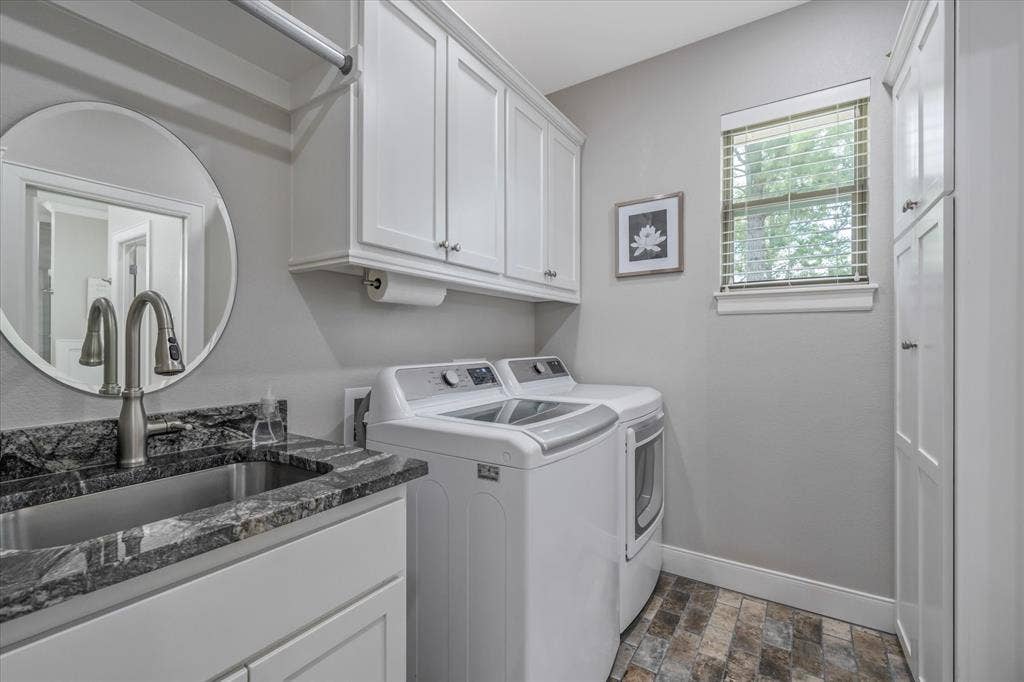 14486 Meadow Glen, Lindale, TX 75771 Utility room featuring a built-in sink with a countertop, white cabinetry, wood-finish flooring, and a window with blinds