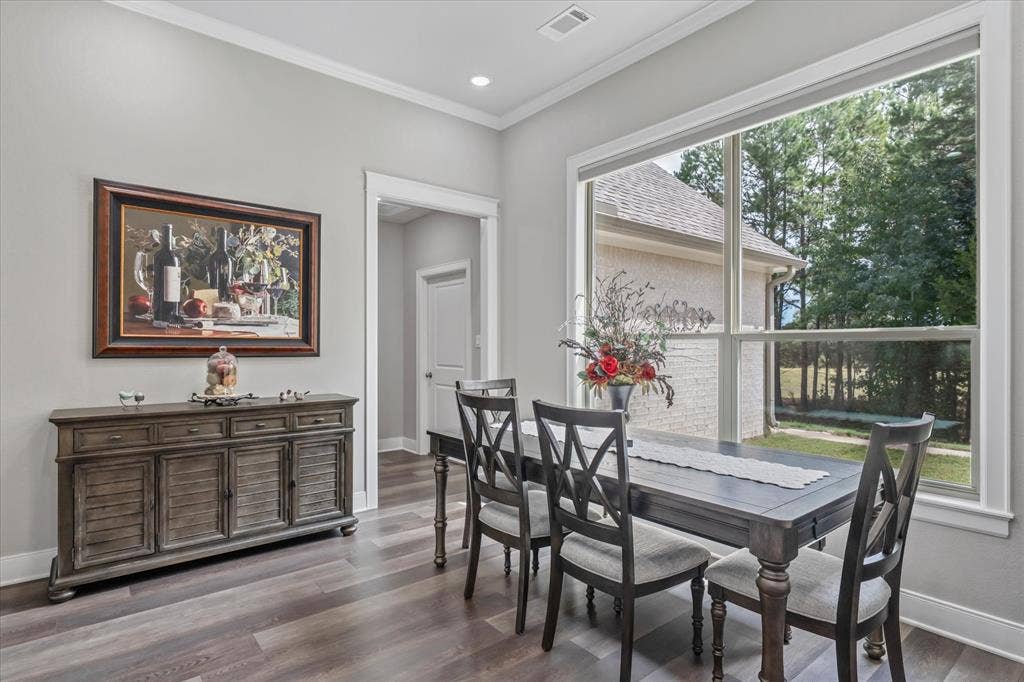 14486 Meadow Glen, Lindale, TX 75771 Expansive window with white trim, wood-finish flooring, and crown molding