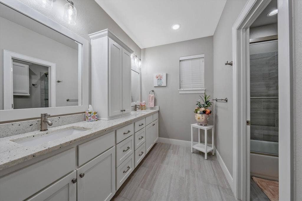 14486 Meadow Glen, Lindale, TX 75771 Double vanity with integrated sinks, white cabinetry, speckled countertop, and wood-finish flooring