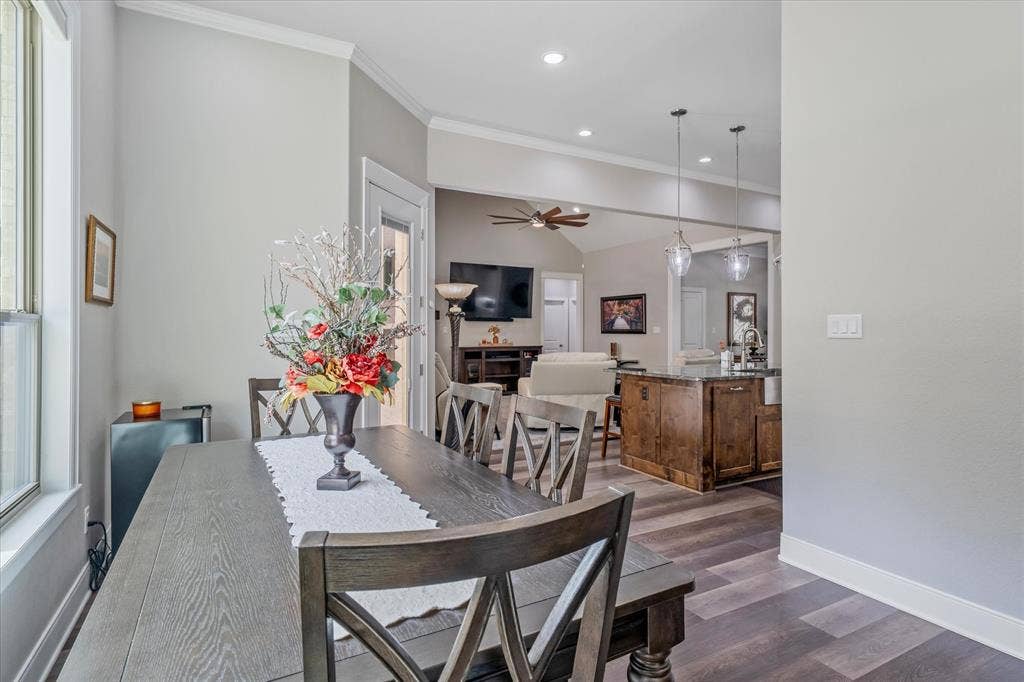 14486 Meadow Glen, Lindale, TX 75771 Recessed lighting, wood-finish flooring, vaulted ceilings, and a kitchen island with pendant lighting