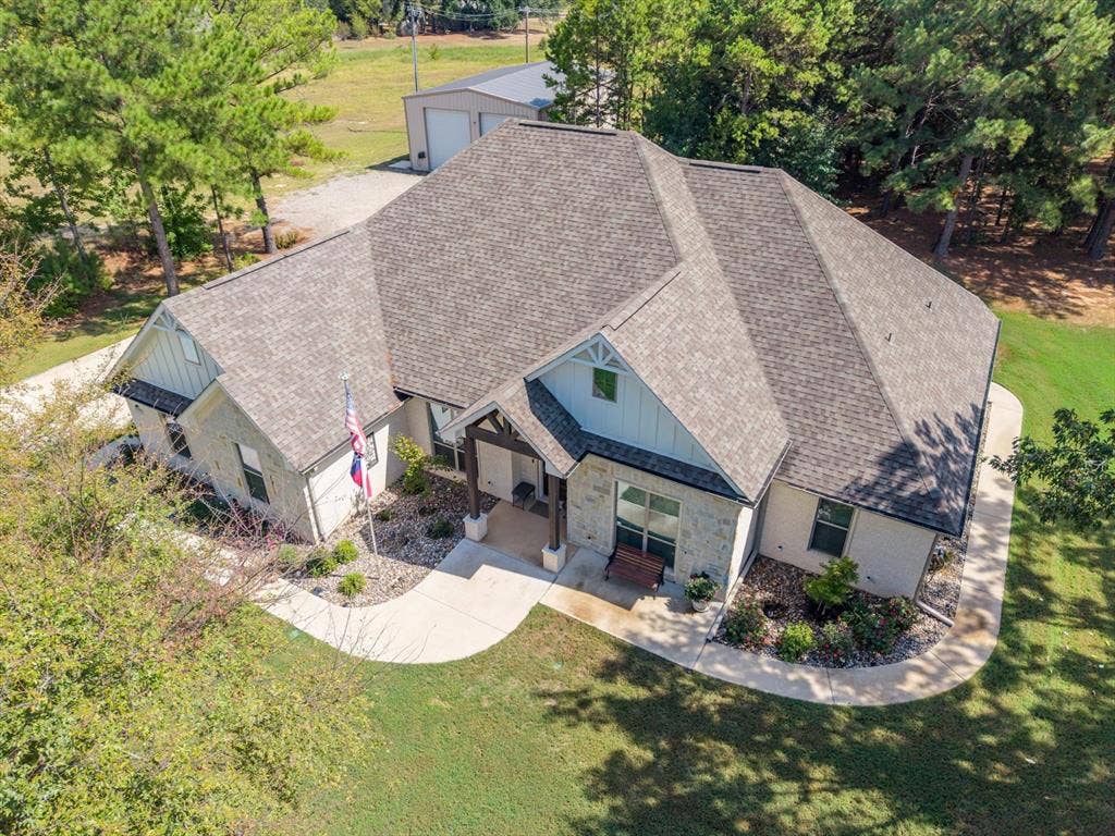 14486 Meadow Glen, Lindale, TX 75771 Stone and siding exterior with a multi-gabled roofline