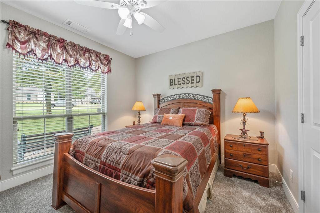 14486 Meadow Glen, Lindale, TX 75771 Wall-to-wall carpeting with light gray walls and a white ceiling fan