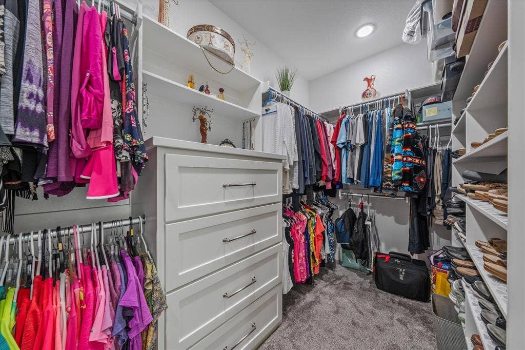 14486 Meadow Glen, Lindale, TX 75771 Walk-in closet featuring built-in shelving, hanging rods, and a multi-drawer dresser unit with chrome hardware