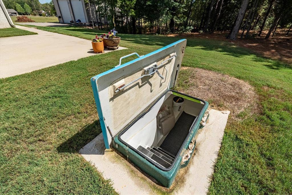 14486 Meadow Glen, Lindale, TX 75771 Subterranean access point featuring interior steps and a robust entry hatch