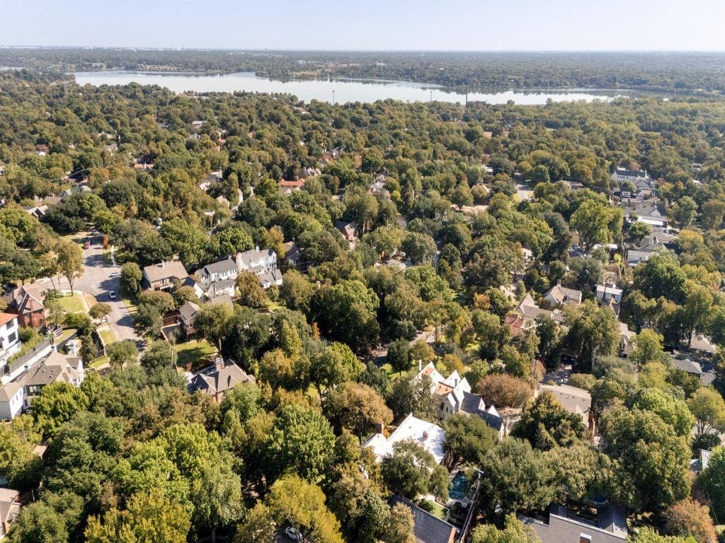 6858 Tokalon Drive, Dallas, TX 75214 Aerial perspective featuring mature tree canopy, dense residential landscaping, and proximity to a large body of water