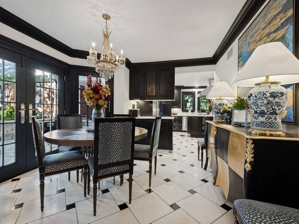 6858 Tokalon Drive, Dallas, TX 75214 Dining area featuring crown molding, black-framed French doors, a crystal chandelier, and geometric tile flooring