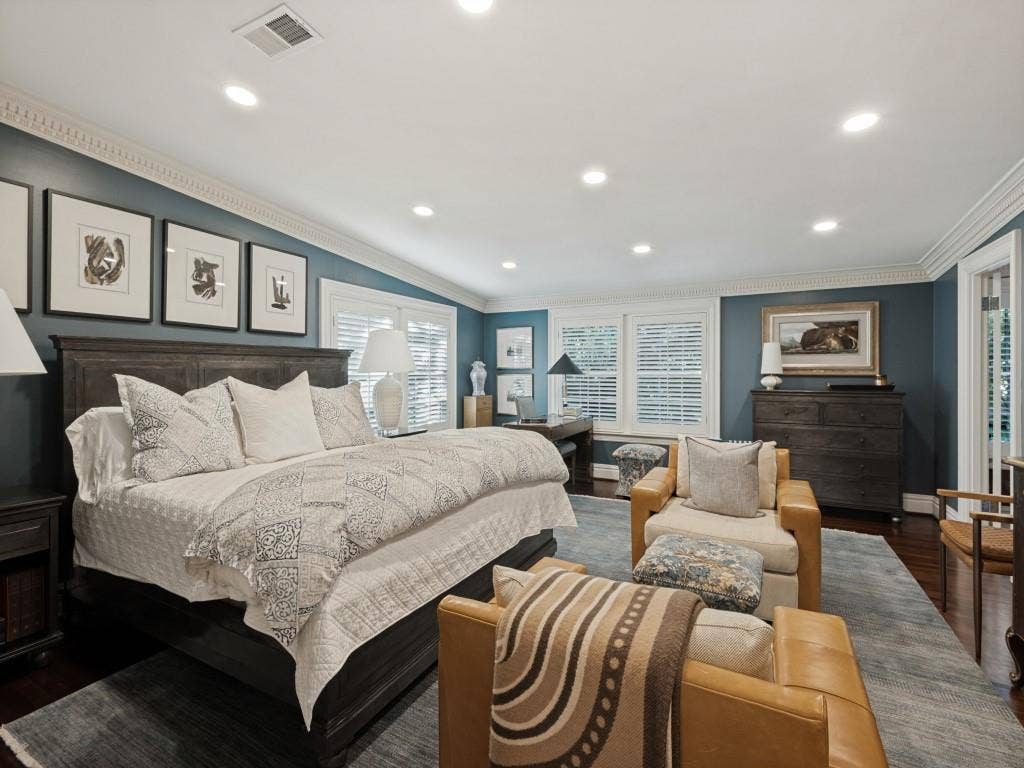 6858 Tokalon Drive, Dallas, TX 75214 Spacious room featuring crown molding, recessed lighting, dark-toned walls, wood-finish flooring, and multi-pane shutters