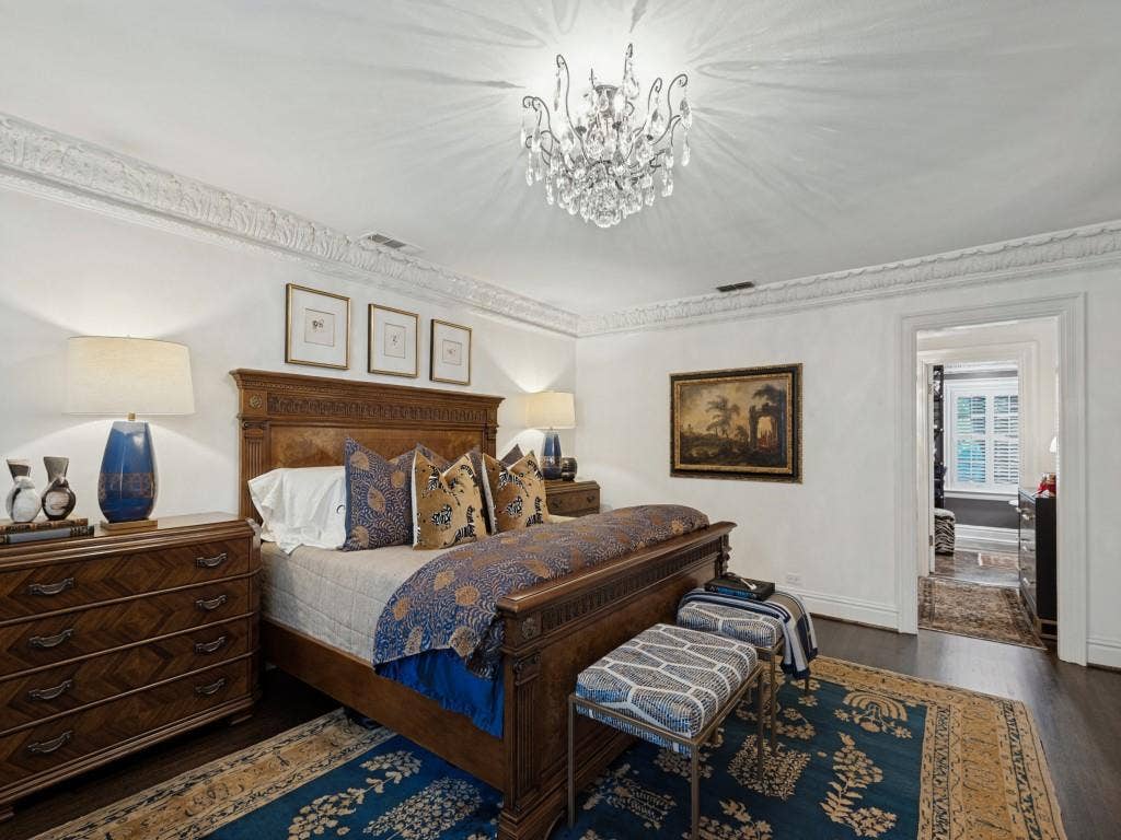 6858 Tokalon Drive, Dallas, TX 75214 Ornate crown molding, dark wood-finish flooring, and a crystal chandelier