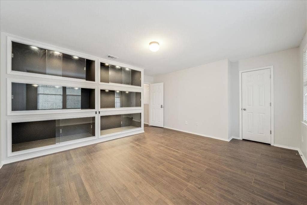 Built-in display cabinetry with sliding glass doors and integrated lighting