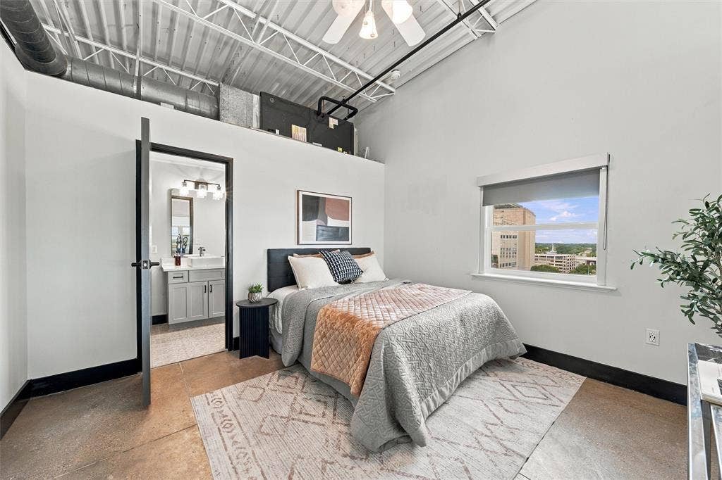 219 S 4th Street, #608, Waco, TX 76701 Exposed industrial ceiling, concrete flooring, window with roller shade, interior doorway, and built-in loft storage