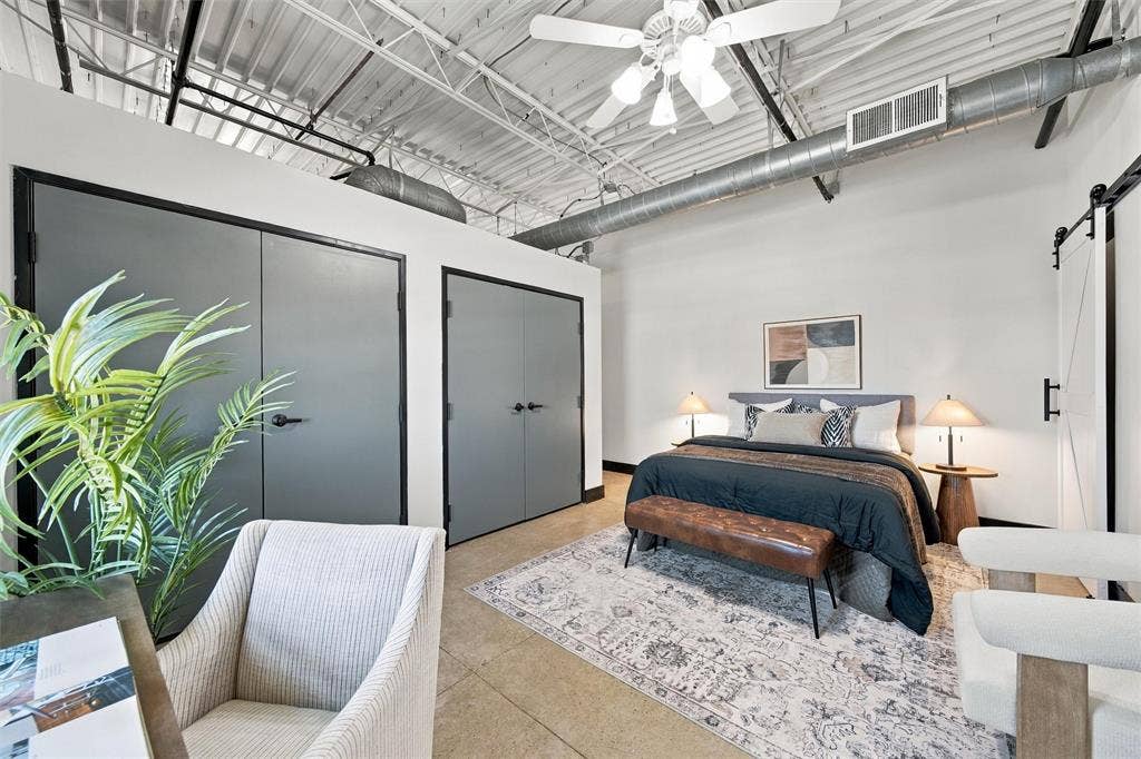 219 S 4th Street, #608, Waco, TX 76701 Exposed ductwork and white painted ceiling joists, ceiling fan with light kit, concrete flooring, and a white barn door