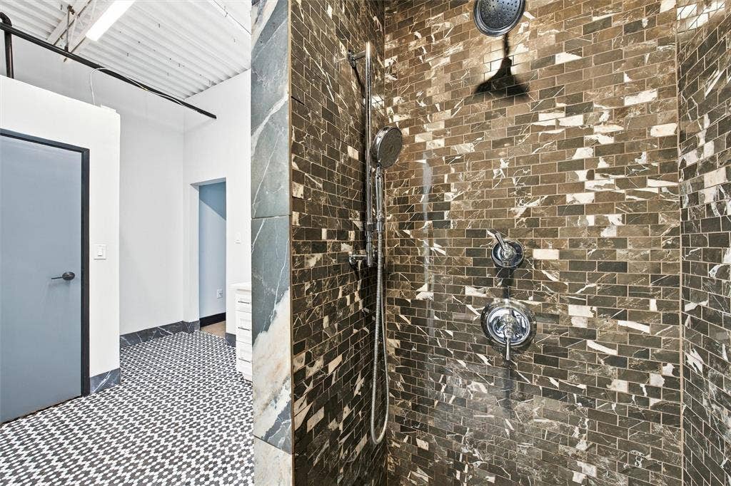 219 S 4th Street, #608, Waco, TX 76701 Shower featuring rich, varied rectangular wall tiling and polished chrome fixtures