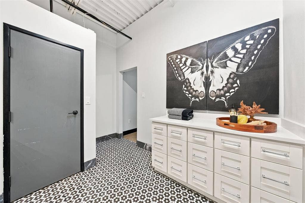 219 S 4th Street, #608, Waco, TX 76701 White cabinetry with polished hardware, white countertop, and patterned floor tile