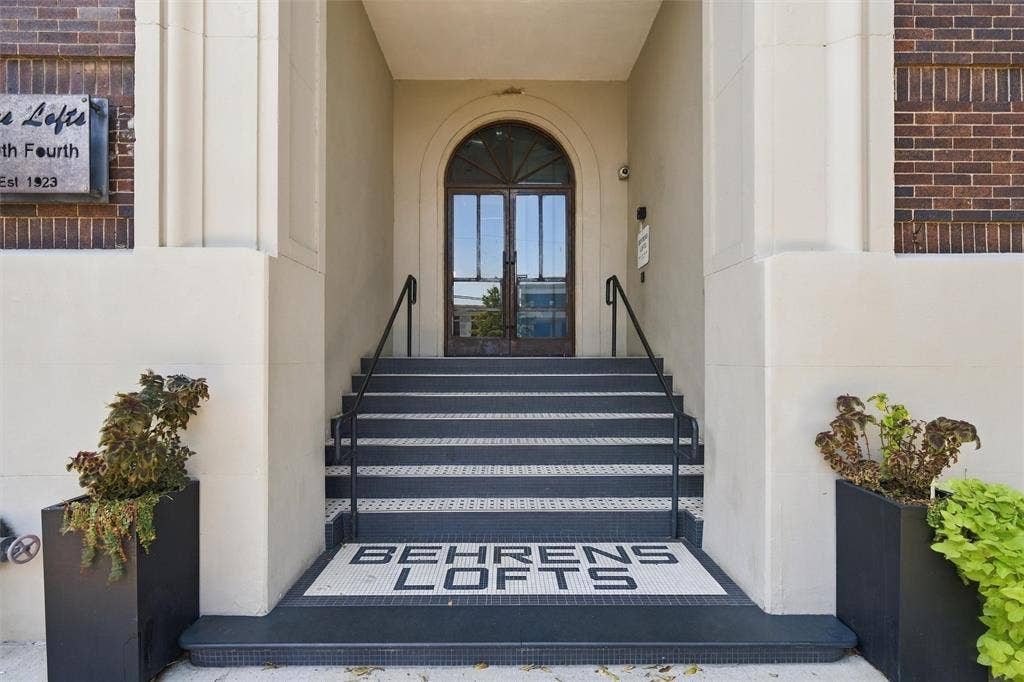 219 S 4th Street, #608, Waco, TX 76701 Arched entryway with double glass doors, mosaic tile landing, and black handrails