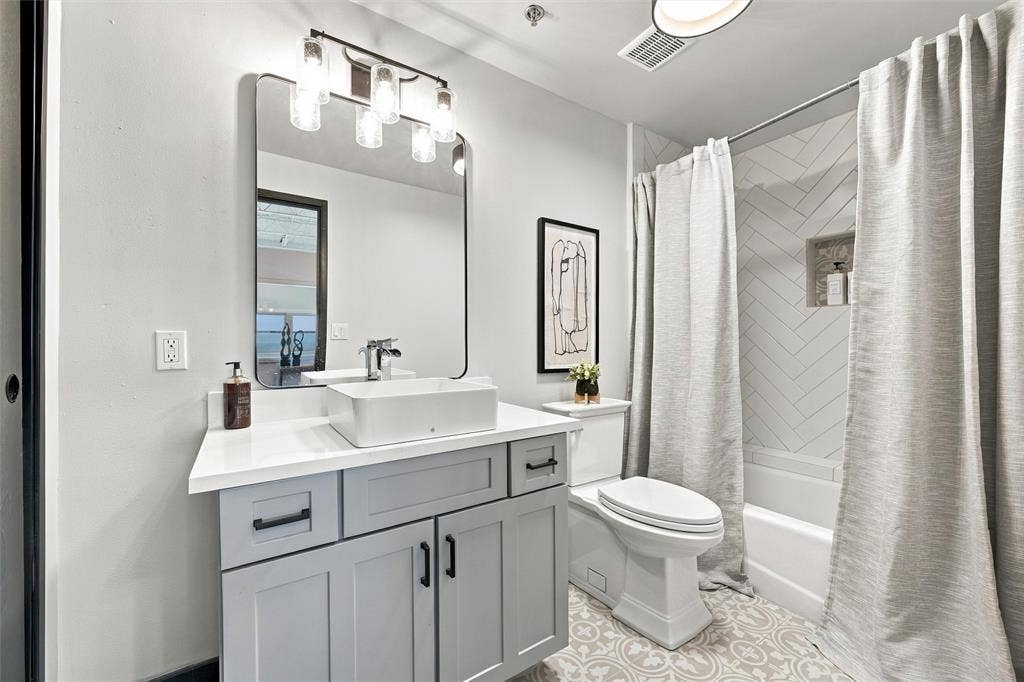 219 S 4th Street, #608, Waco, TX 76701 Modern vanity with a rectangular vessel sink, quartz countertop, and matte black hardware