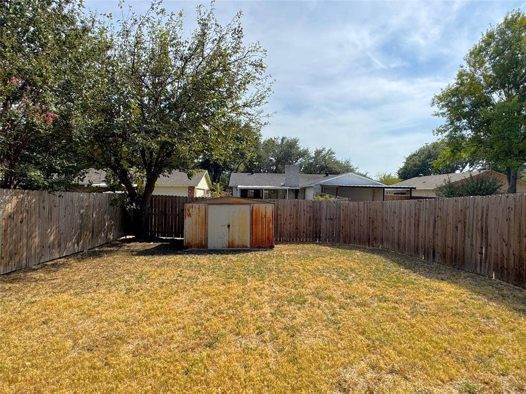 2525 Norway Drive, Garland, TX 75040 Private backyard with a storage shed