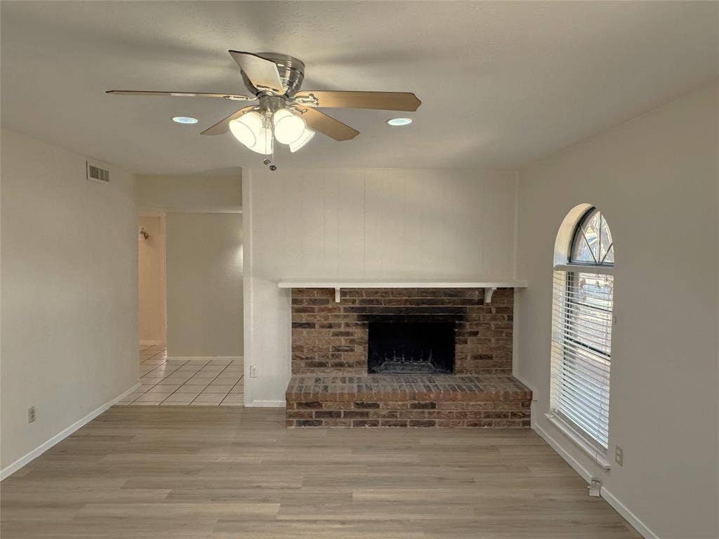 2525 Norway Drive, Garland, TX 75040 Living room with brick, wood burning fireplace