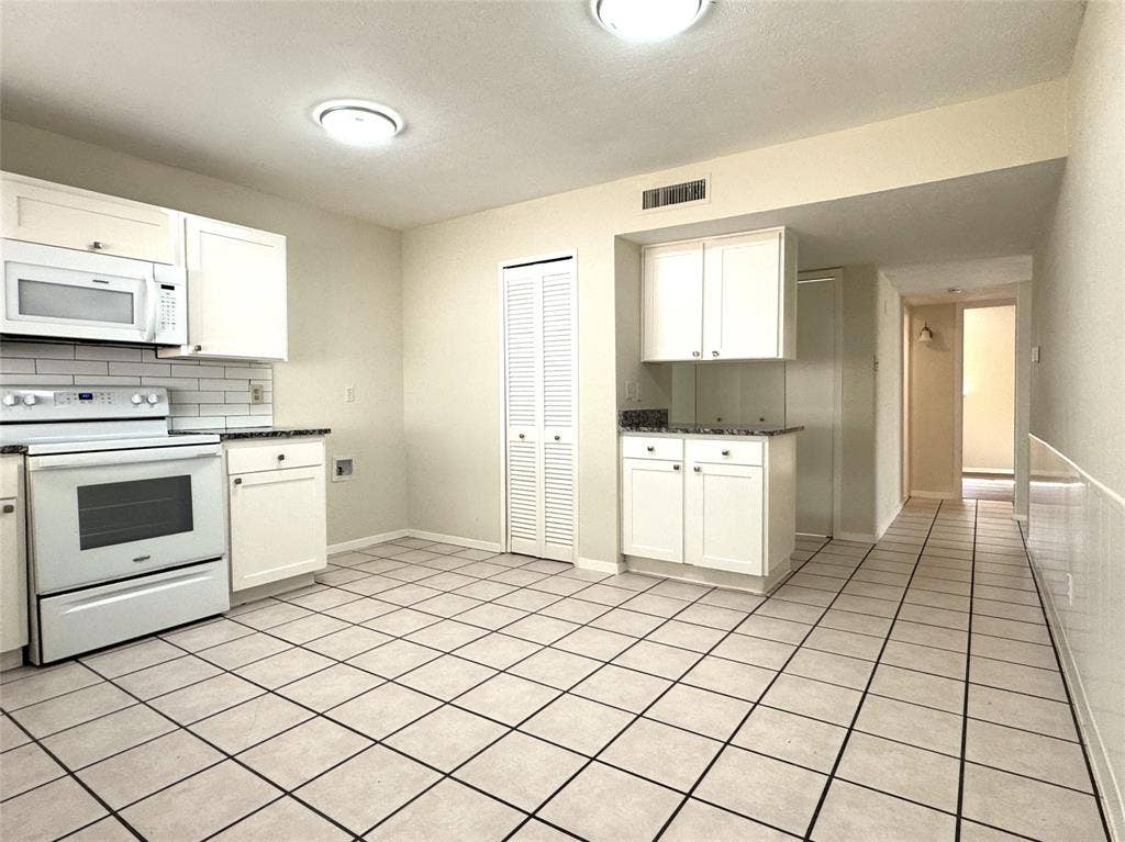 2525 Norway Drive, Garland, TX 75040 Spacious kitchen boasts granite countertops and white subway tile backsplash