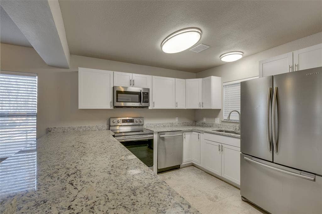 157 Harborr Drive, Gun Barrel City, TX 75156 Kitchen with appliances with stainless steel finishes, white cabinets, and granite counters