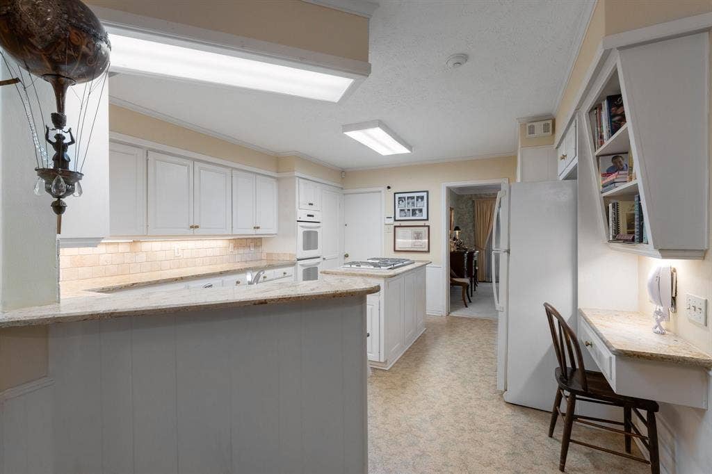 6950 Midcrest Drive, Dallas, TX 75254 Built in desk area and cook book shelving.