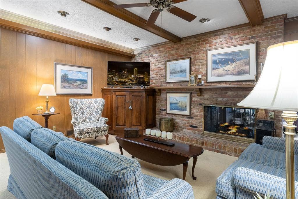6950 Midcrest Drive, Dallas, TX 75254 Brick wall fireplace see through to the Sun Room.