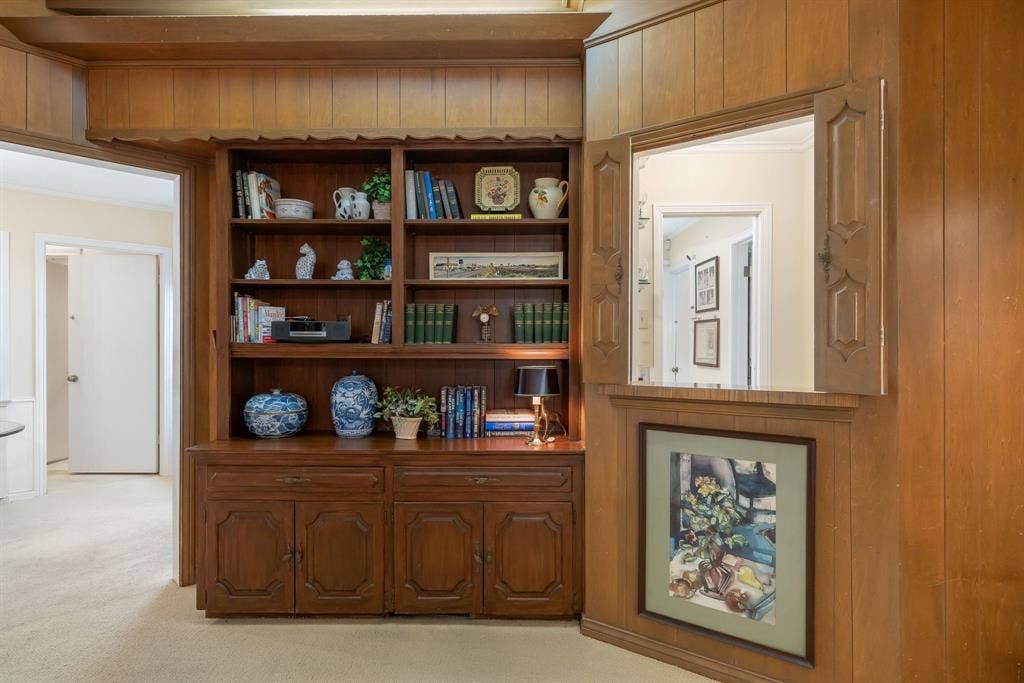 6950 Midcrest Drive, Dallas, TX 75254 Family room with built in bookshelf and cabinets.