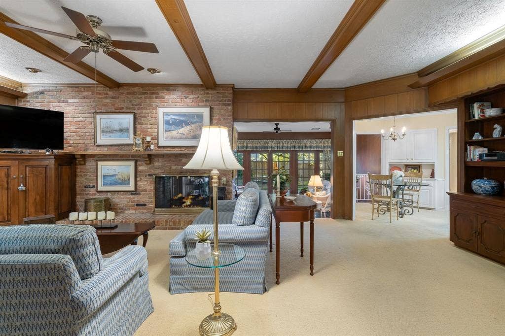 6950 Midcrest Drive, Dallas, TX 75254 Family Room with beamed ceiling open to Kitchen and Sun Room.