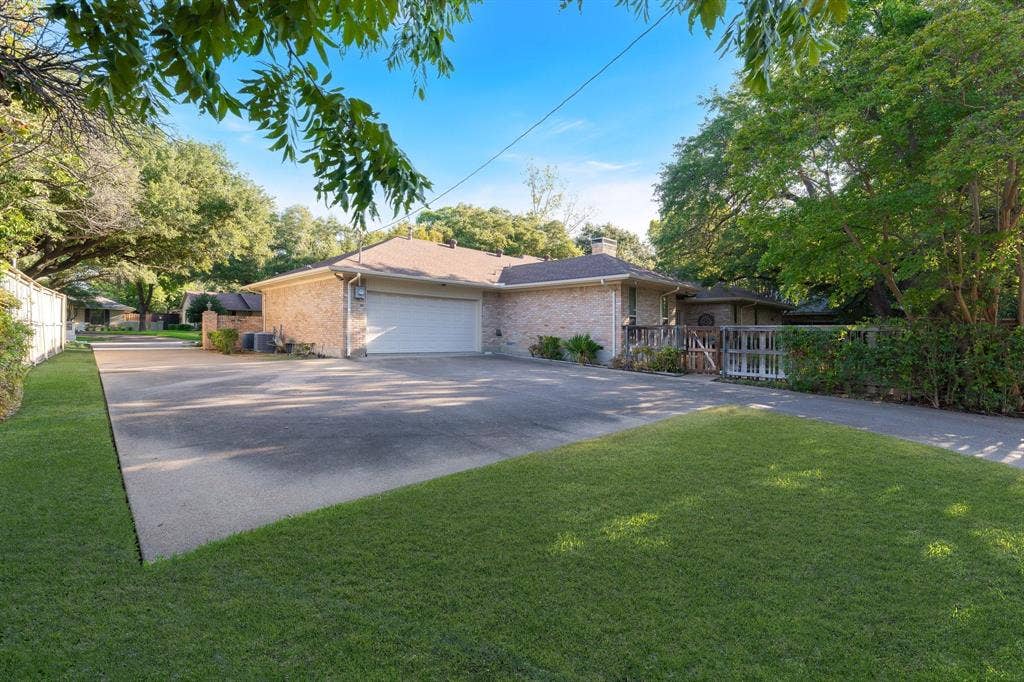 6950 Midcrest Drive, Dallas, TX 75254 Drive way goes from front of home to Alley and garage can be entered both ways. Extra parking in front of home and back.