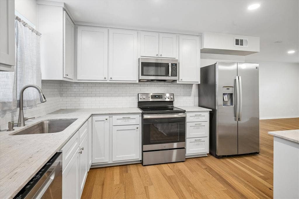 Well Lit Kitchen With Granite/Granite Type Counters