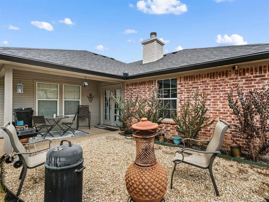 3012 Pinto Loop, Robinson, TX 76706 Brick exterior with shingle roofing, covered patio, white-framed windows, and French doors