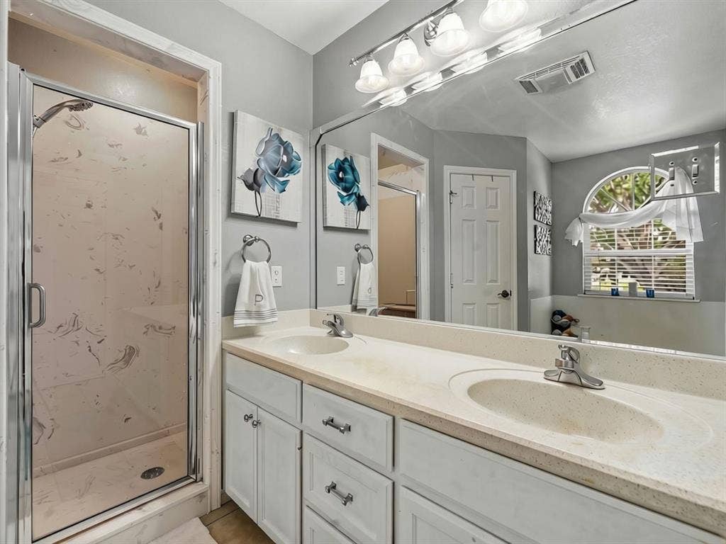 3012 Pinto Loop, Robinson, TX 76706 Dual vanity with integrated sinks, white cabinetry, and a full-width mirror