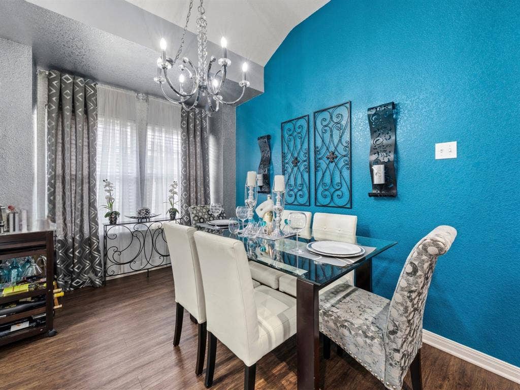 3012 Pinto Loop, Robinson, TX 76706 Vaulted ceiling, wood-finish flooring, chandelier, double windows, and a glass-top table