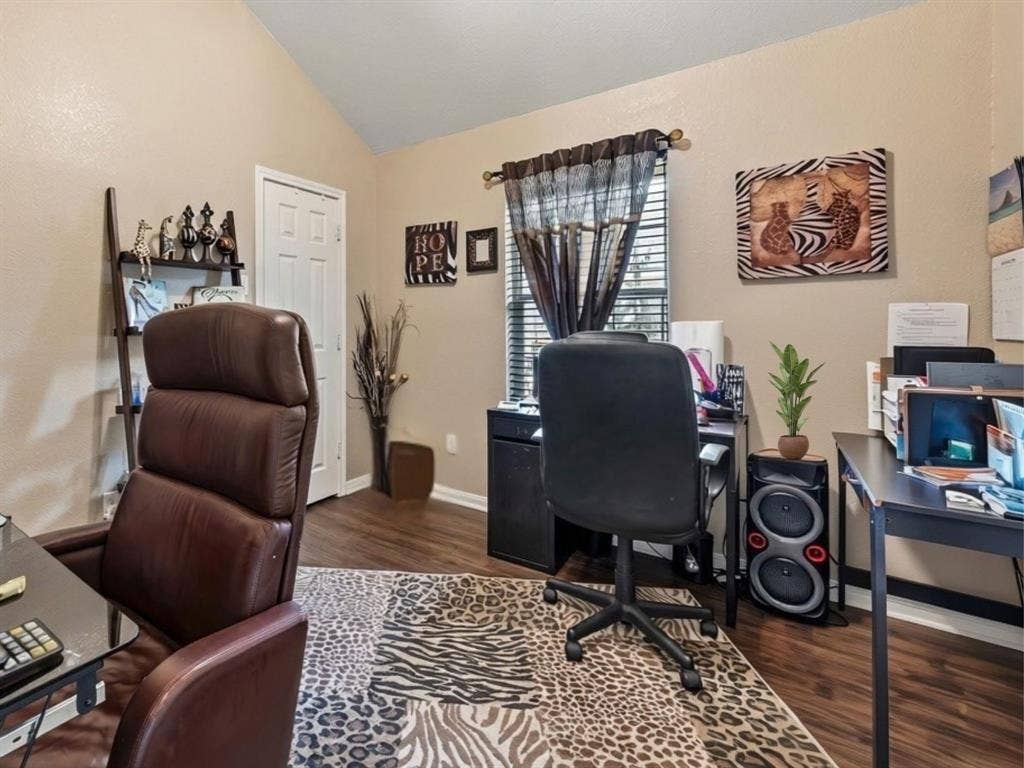 3012 Pinto Loop, Robinson, TX 76706 Vaulted ceiling with wood-finish flooring, white paneled interior door, and window with blinds